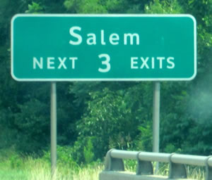 An image of a guide sign is shown with the legend "Salem NEXT 3 EXITS." The lower-case letters of the word Salem are much smaller than the accepted height for the corresponding initial upper-case letter.